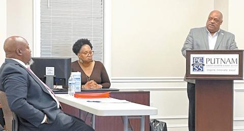 Putnam County School Superintendent Derick Austin (left) and Eatonton Mayor John Reid converse about the old elementary school building. LYNN HOBBS/Staff