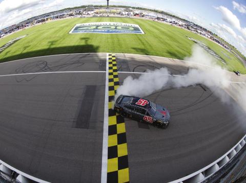 Kurt Busch, driver of the #45 Jordan Brand Toyota, celebrates with a burnout after winning the Cup Series AdventHealth 400 at Kansas Speedway Sunday. (Sean Gardner/Getty Images)