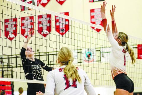 Morgan County’s Presley Hill (11) and Makenzie Pitzer (1) get set to make a play at the net against Winder-Barrow last week. LANCE McCURLEY/Staff