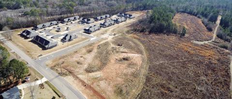 The proposed workforce housing development will be located on 52 acres of land (foreground) that is adjacent to the recently opened Villages at Baynes Creek senior living community on Oconee Avenue. MARK ENGEL/ Staff