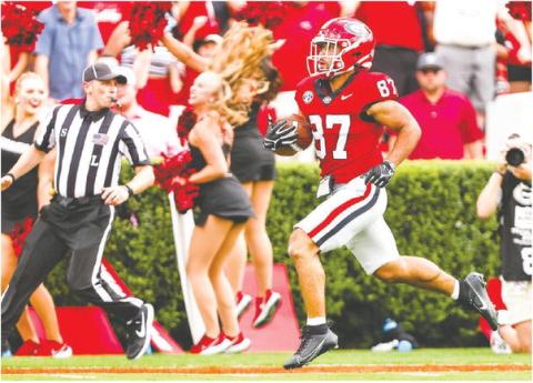 Mekhi Mews (87) breaks away from Ball State defenders during a 69-yard punt return, which sparked the Bulldogs to score 45 unanswered points. TONY WALSH/UGA Athletics