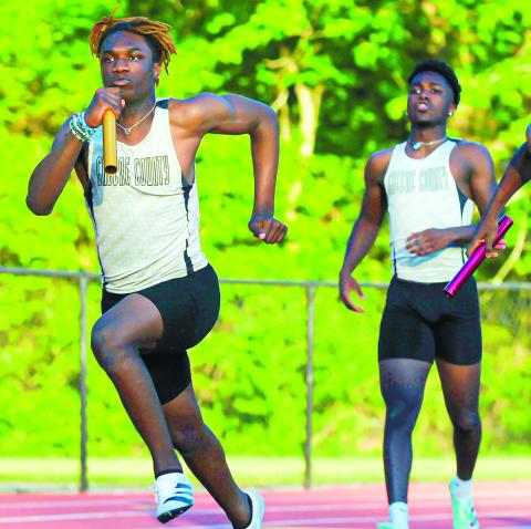 The Greene County 4X100 relay team passing the baton off between teammates. The group would place second overall at the state meet. CHARLES JORDAN/Contributed