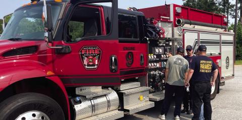 Morgan County Battalion Chief Allen Hagler and firefighters Trenton Robinson and Russell Cook inspect a fire truck. CONTRIBUTED