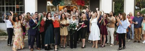 With plenty of support from friends and colleagues, Jackie Greer (center with black scissors) made the official ribbon cut for her new space for Greer Force Marketing at 1001 Village Park Dr., Unit 108, in Greensboro. IAN TOCHER/Staff