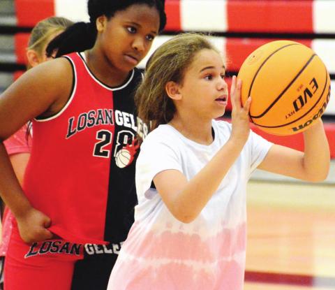 Elementary and middle school aged girls playing a game called “knockout” to work on their shooting. BRENDAN KOERNER/Staff