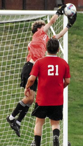 Morgan County keeper Blake Downs leaps to make a save in the first half against Jackson. IAN TOCHER/Staff