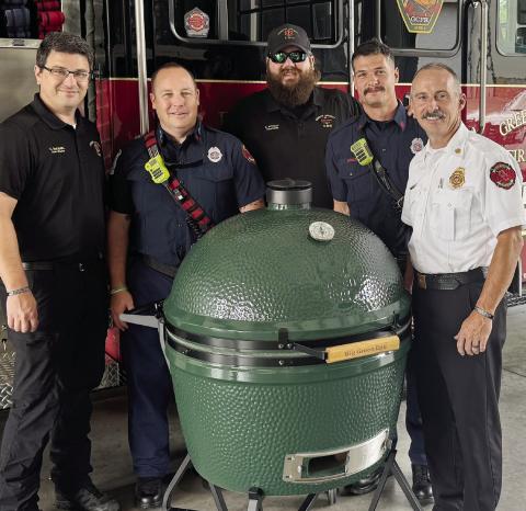 Chief Rodney Wiggins of Greene County Fire and Rescue sends a big thank you to Donna and Paul Hyland and the Boys and Girls Club of Green County as he accepts the raffle prize from this past weekend‘s BBQ Fest held at the Farm at Oconee. CONTRIBUTED