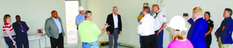 District 10 Congressman Mike Collins (center) speaks with Putnam County Manager Paul Van Haute (in green), with (l-r) County Clerk Lynn Butterworth, Eatonton Councilmember Janie Reid and Eatonton Mayor John Reid among local dignitaries touring the county’s new fire station under construction behind the county offices off the Hwy. 441 bypass. IAN TOCHER/Staff
