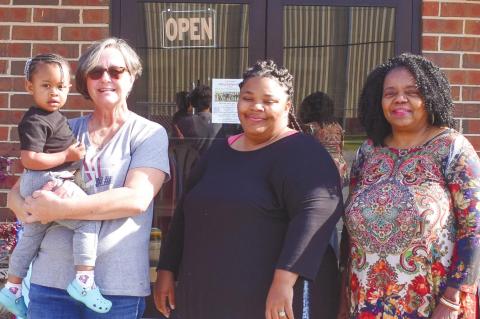From left to right, volunteer Shelby Beauchamp holding Mazi Mathis, volunteer Lynda Farley and Executive Director Vanessa Jackson. BAILEY BALLARD/Staff