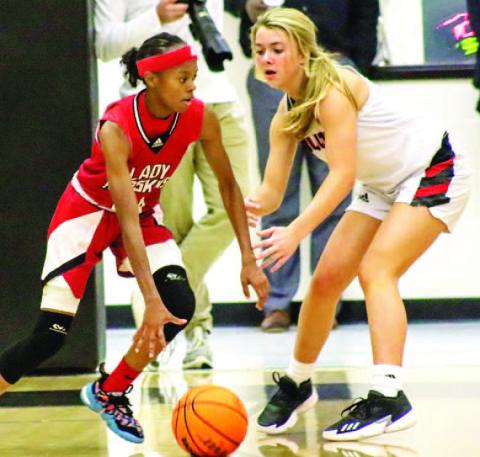 Freshman Sadie Bartlett (1) defends a Lady Redskins guard, not allowing her to drive inside the paint. LANCE McCURLEY/Staff