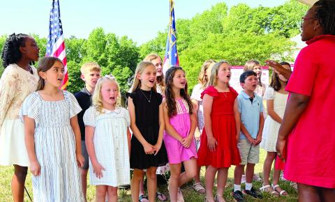 Morgan County Primary and Elementary School students sing the national anthem to open the Thursday morning groundbreaking ceremony. SKYLA MORRIS/Staff