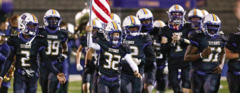 The Lake Oconee Academy Titans take the field before their game against rival Greene County on Oct. 24. LANCE McCURLEY/Staff