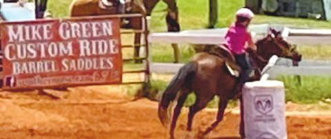 One of the competitors turns sharply around the barrel. BAILEY CLARK/Staff