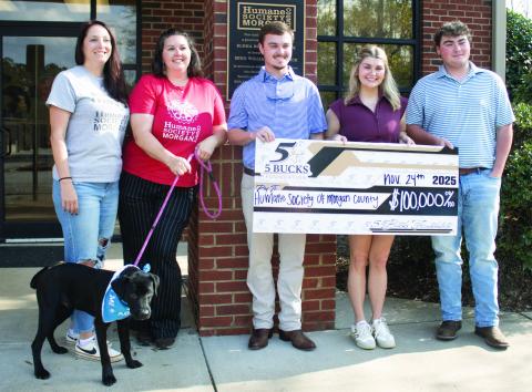 HSMC employees take a photo alongside Garrett, Gabrielle, and Griffin Smith as part of the $100,000 check presentation. CONTRIBUTED
