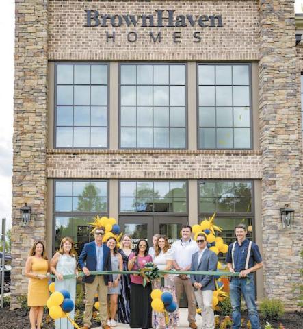 Brown Haven Homes staffers cut the ribbon alongside the Greene County Chamber of Commerce, to celebrate the site’s grand opening. T. MICHAEL STONE/Staff