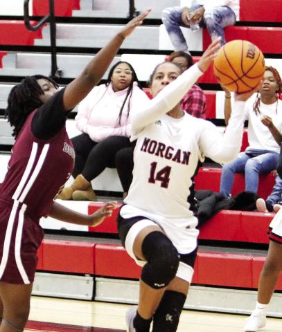 Morgan County junior Jaden Young (14) scored a team-high 18 points during a win over Dougherty during the first round of the Class AAA state playoffs. LANCE McCURLEY/Staff