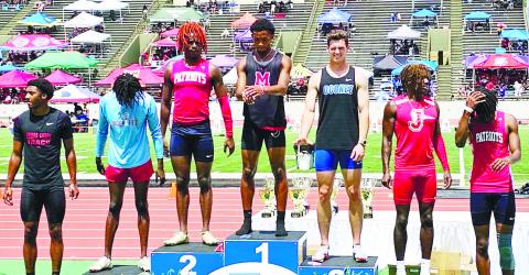 Morgan County’s Josh Jones (No. 1) sits at the top of the podium after winning the Class AAA 300-meter hurdles state championship. CONTRIBUTED