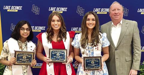 Frank Rowan, Lake Oconee Lodge scholarship chair, presents awards to (L-R) Ridhadhi Sukha, Gabriella Blythe and Sydney Pattison. CONTRIBUTED