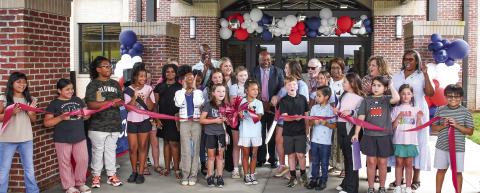 Along with several Putnam County Elementary School students at the ribbon cutting, Putnam County Board of Education Superintendent Derick Austin (center, pink tie) was joined by BOE board members Charles Trumbo (left, back row), BOE Chair Dr. Steve Weiner (sunglasses), and (l-r, back row,) Doris Clemons, Carol Ann Guthrie, and Rev. Simone Jones. PCES Principal Whitney Smith is standing to Austin’s right. IAN TOCHER/Staff