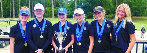 The Lake Oconee Academy girls golf team raised its third straight state championship trophy after winning the GHSA Class A Division II title. CONTRIBUTED