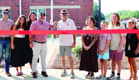 The families of Bennett Rabern and Avett Jackson did the honors of cutting the ribbon for the Rabern-Jackson Memorial Garden July 30 at Morgan County Middle School. SKYLA MORRIS/Staff