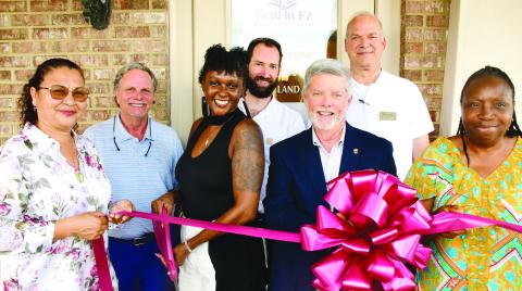 Latonya Taylor (third from left) prepares to cut the ribbon to officially open her Heal In-Ez Reiki &amp; Wellness Spa Aug. 5, in a ceremony hosted by the Eatonton-Putnam Chamber of Commerce. IAN TOCHER/Staff
