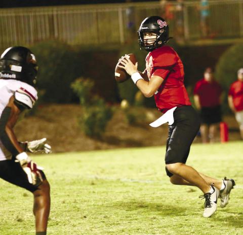 Morgan County quarterback Davis Strickland drops back to pass in a game earlier this season. JIM TURNER/Contributed
