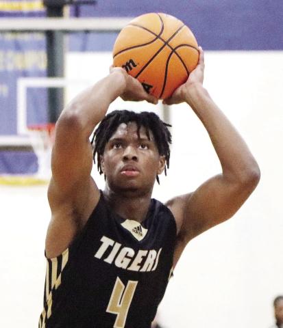 Greene County’s Laryous Burt (4) attempts a free throw in the region championship game against Warren County on Feb. 16. Burt will return next season for the Tigers. LANCE MCCURLEY/Staff