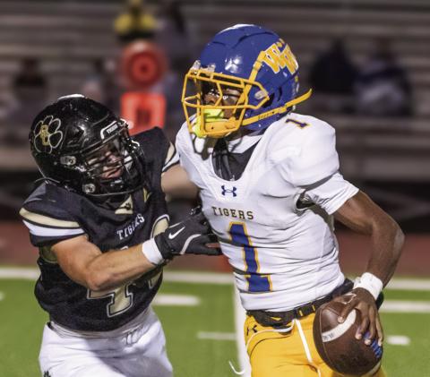 Washington-Wilkes quarterback Mayson Mingle (1) stiff arms a Greene County defender. SKYLA MORRIS/Staff