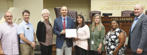 GDAA Auditor Luke Edwards (left center) presents the Award of Distinction for Excellent Financial Reporting to GCSS Chief Financial Officer Connie Wilkes and Assistant CFO Holly Dumdie (center right) joined by Board of Education members (l-r) Steve Kilgore, Dr. Perry Lee, Dr. Maggie Kjer, and Regina Gainer with Superintendent Dr. Chris Houston (far right). CONTRIBUTED