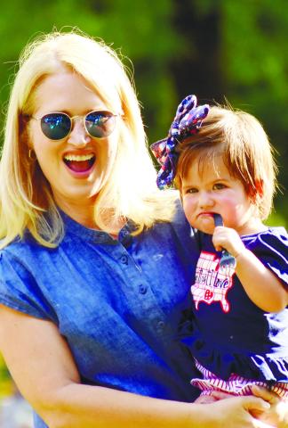 A woman and her daughter watch along as the band performs.