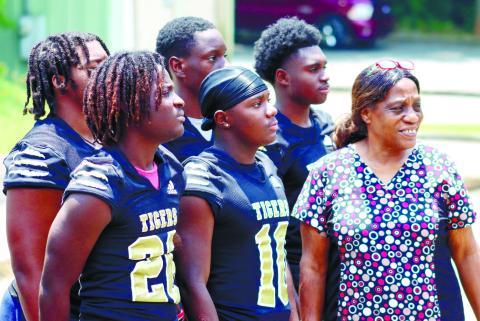 Members of the Greene County football team look on as they learn how to clean industrial-sized kitchen equipment. LANCE MCCURLEY/Staff