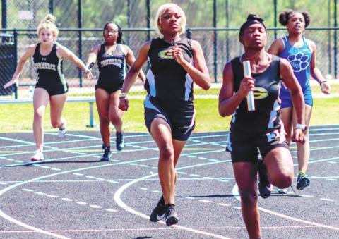 Members of the Lady Tigers’ 4x100-meter relay team right after the final exchange. LANCE McCURLEY/Staff