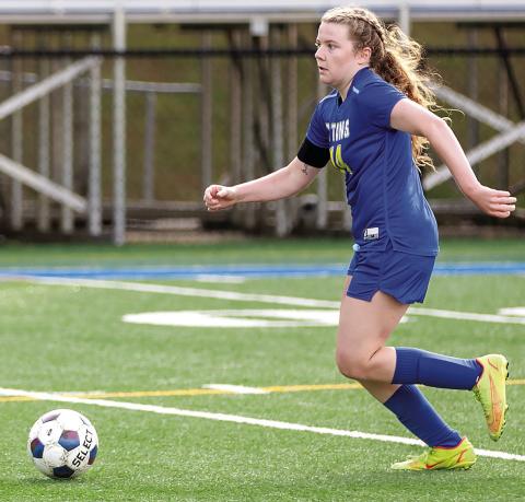 Senior Ansleigh Padgett dribbles downfield away from defenders during a match last season. SKYLA MORRIS/Staff
