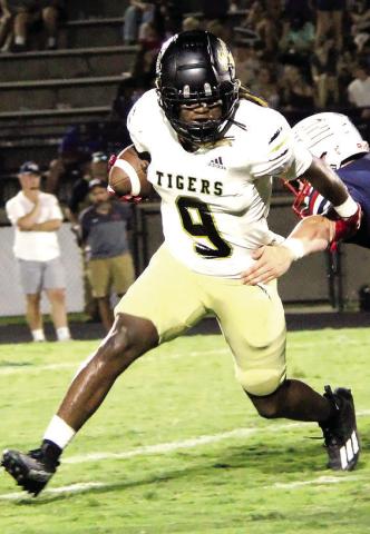 Greene County running back Amari Durham (9) tries to dodge a Haralson County defender. (COURTESY OF MAMA D'S PIX)