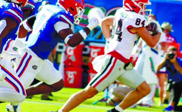 Georgia wide receiver Ladd McConkey (84) runs away from Florida defenders for a 41-yard touchdown. LANCE McCURLEY/Staff
