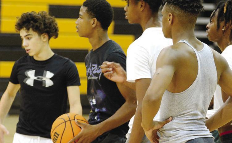 A group of Greene County basketball players waiting for their turn to complete a drill set up by head coach Mark Wright at p ractice earlier this week. BRENDAN KOERNER/Staff