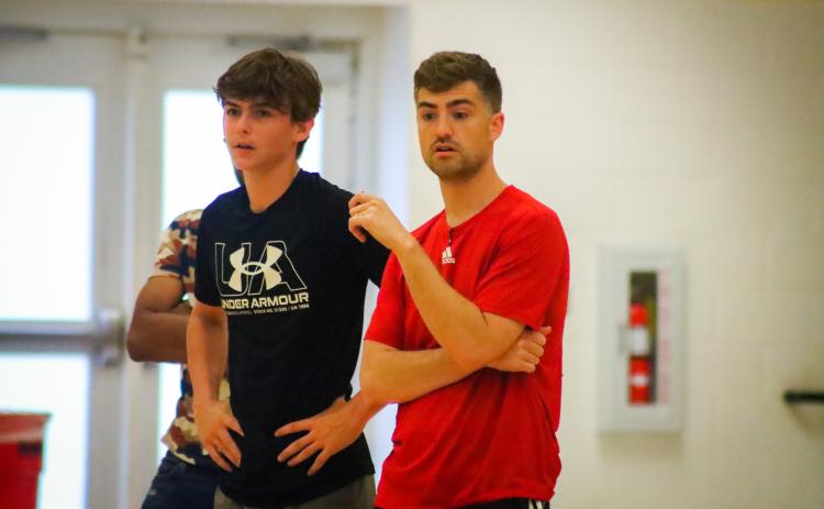 Anderson (right) watches a pick-up game during an open gym held at Morgan County High School on Tuesday night. LANCE McCURLEY/Staff