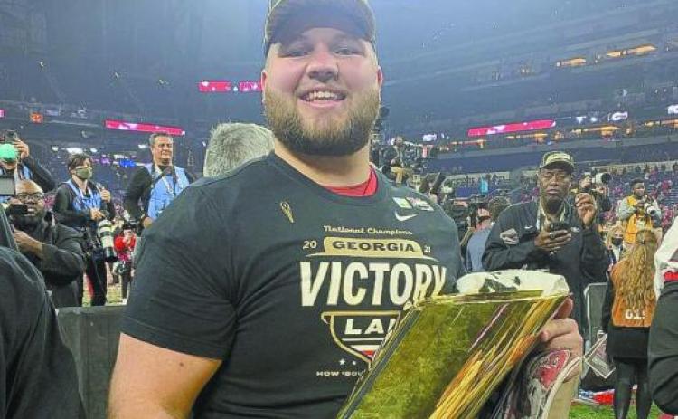 Former Gatewood Gators All-State player Weston Wallace enjoys a moment with the national championship trophy after helping UGA secure its second-straight title-winning season. (Photo/UGA Athletics)