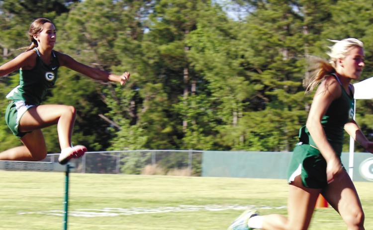 Both Anna Williamson (right) followed by London Darden performed well in girls’ hurdles for the Gatewood team. TREY NORRIS/Staff