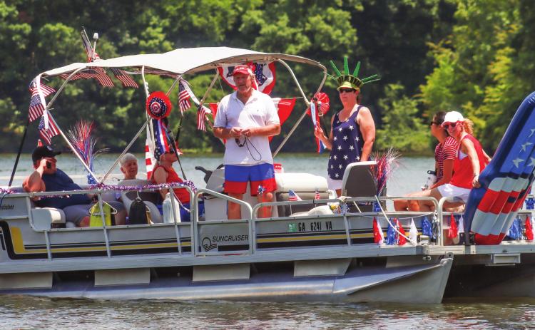 Mark Ruehle (center), along with his friends and family, get ready to participate in the third-annual Lake Oconee Boat Parade.