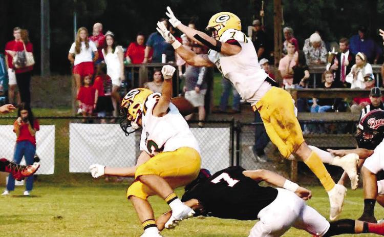 Gatewood’s Evan Bennett (7) leaps forward to successfully block a point-after-touchdown attempt by Briarwood kicker Trey Cotton. (Ball is directly behind the shoulders of Jackson Hewatt (3). DAWN SINCLAIR/Contributed