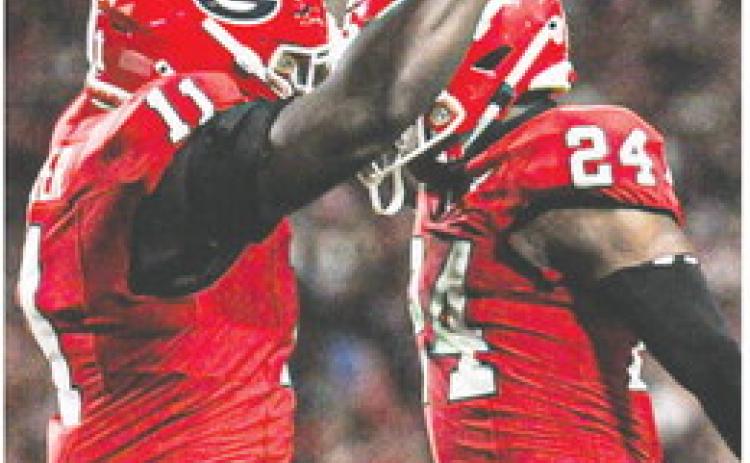 Sophomore linebacker Jalon Walker (11) and defensive back Malaki Starks celebrate during the win over UAB at Sanford Stadium. CHARLES JORDAN/Contributed