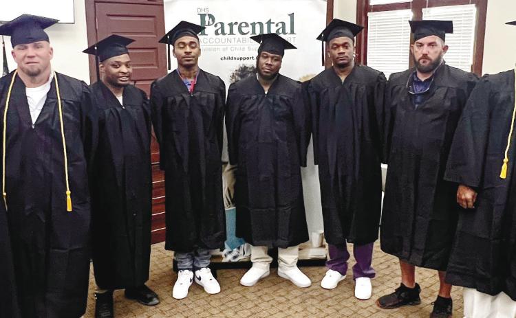 L-R: DCSS Assistant Deputy Commissioner John Hurst and Judge Brenda Trammell pose alongside PAC graduates George Hulsey, Mel-Juwan Lawrence, Bashun Carter, Gregory Burke, Michael Peek, Clarence Hill, Marcus Mathis, Judge Alison Burleson, and PAC Coordinator Zaccino Holmes following Friday’s Parental Accountability Court graduation at Putnam County’s historical courthouse. Not in attendance: PAC graduate James Brock. IAN TOCHER/Staff