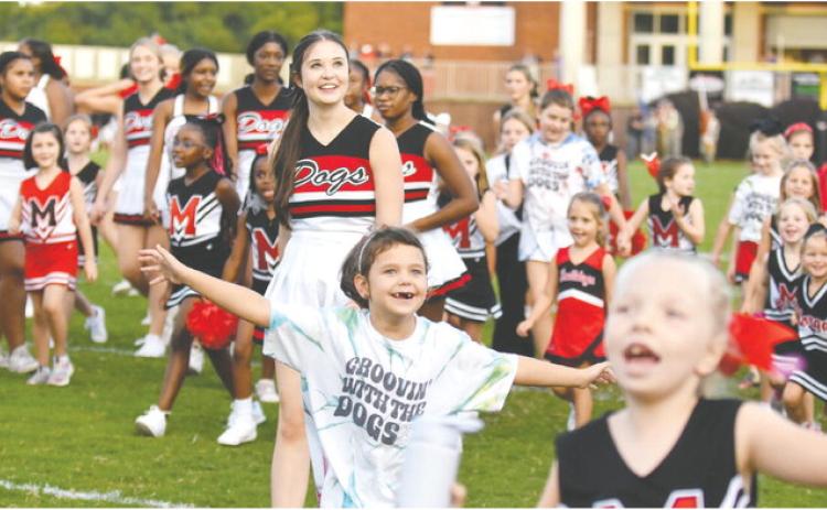 Morgan County youth football cheerleaders celebrate as confetti flies in the air. LANCE MCCURLEY/Staff