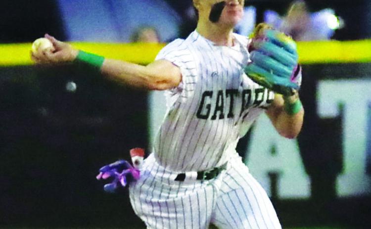 Gatewood senior Ames Johnson tries to make a force out at first base after making a play on an infield ground ball. TREY NORRIS/Staff