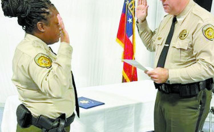 Sheriff Donnie Harrison delivers the Oath of Office to new patrol deputy Quin’sha Goss. CONTRIBUTED