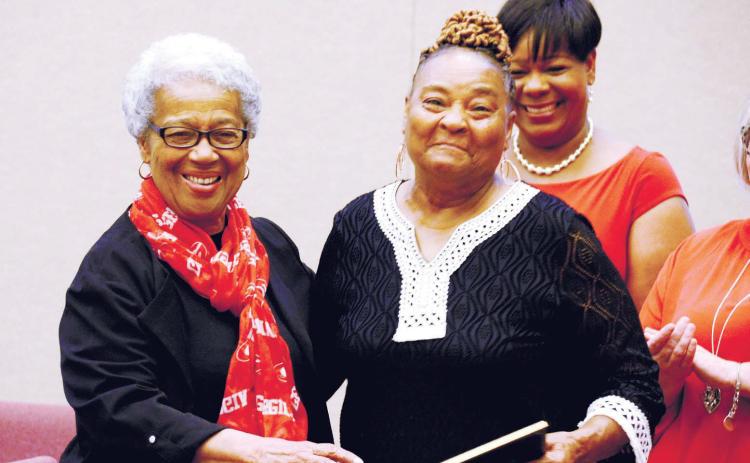 Mothers Against Crime member Brenda Bonner (right), who has been volunteering with the organization since its 1992 inception, received a special service award Saturday night from MAC founder and organizer Georgia Benjamin-Smith. IAN TOCHER/Staff