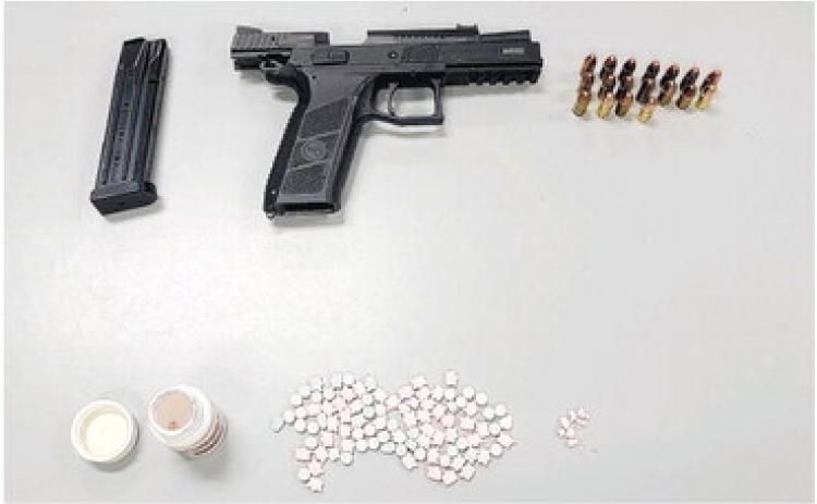 Greensboro police officers found this Cz-PO9 9mm handgun and a large amount of Ecstasy during a traffic stop in the area of East Broad Street. CONTRIBUTED