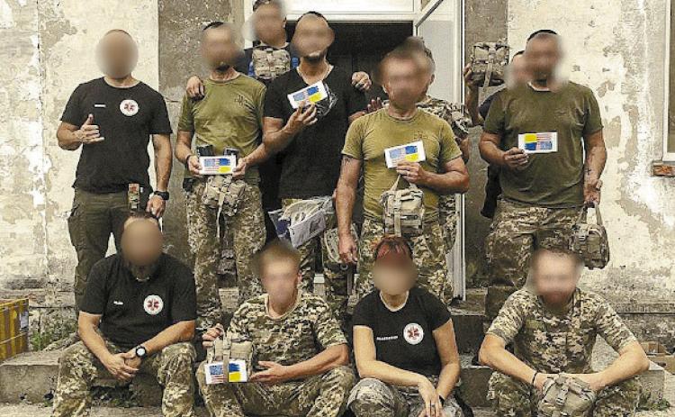 Paramedics in Ukraine (with faces blurred to provide anonymity) pose with medical supplies sent by Lake Country Medical Aid for Ukraine (LCMAU). CONTRIBUTED